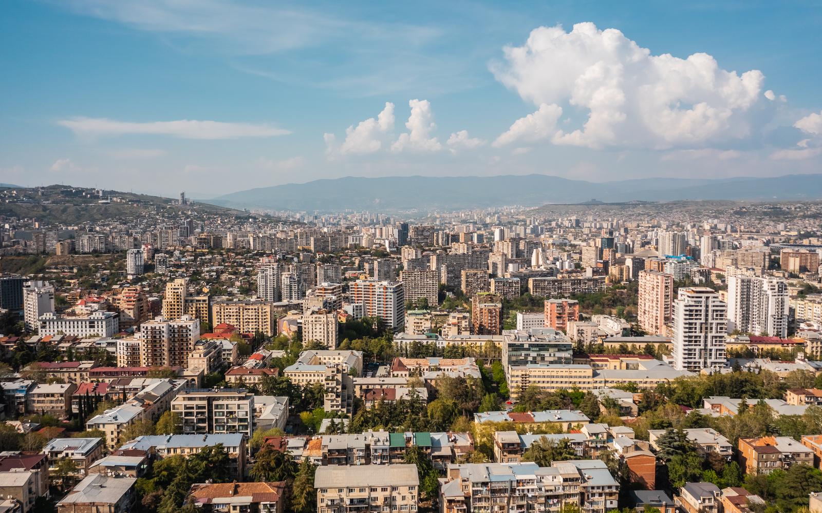 Speed limiter Georgia fleets: Tbilisi city view from above with mountains behind