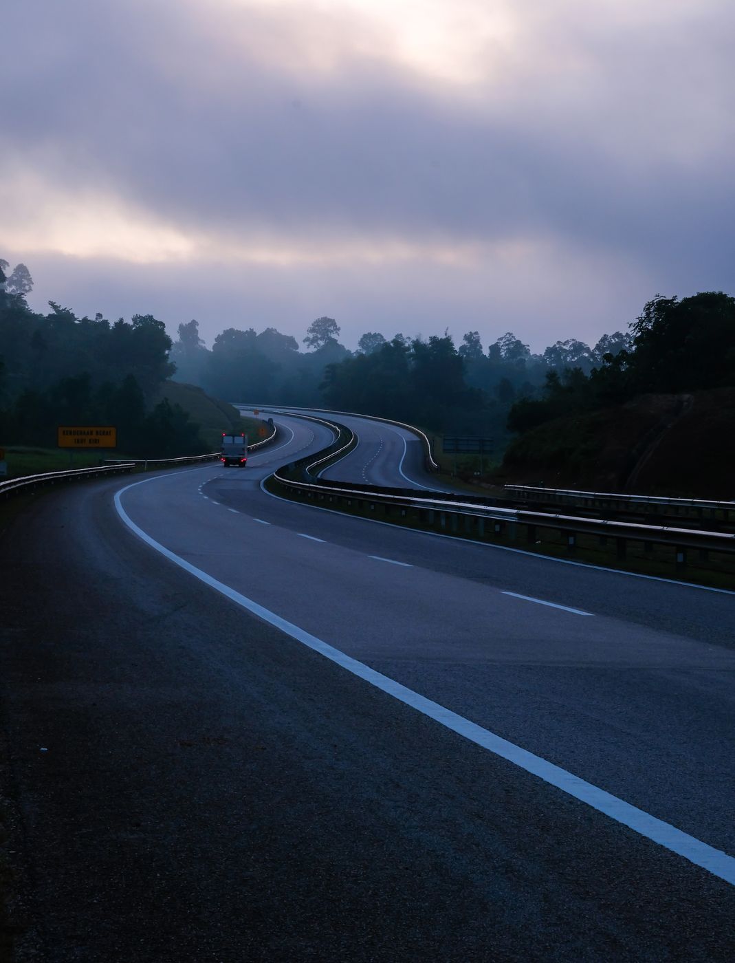 East Coast Expressway curving through forest at dawn, the main road corridor for Kuantan JPJ speed limiter fleets