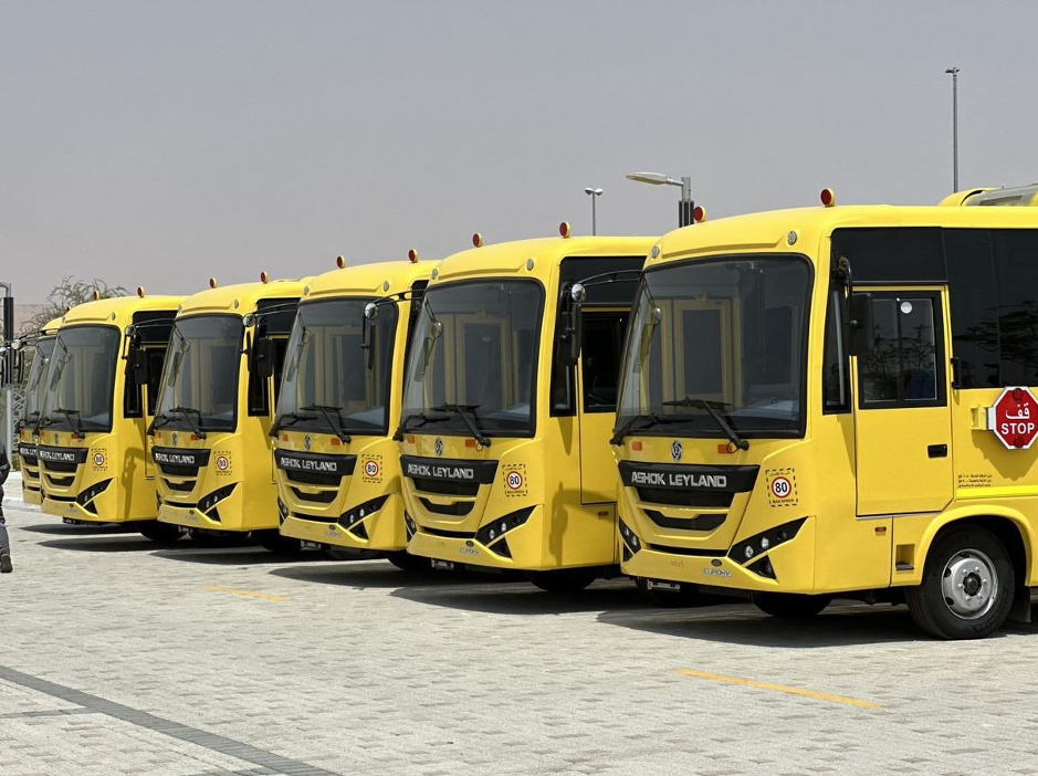 Row of yellow school buses parked side by side