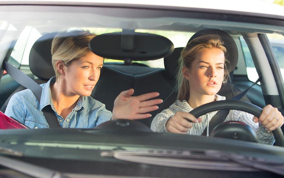 Teen driver practicing with instructor in Washington DC, building safe driving habits through DMV learner program.